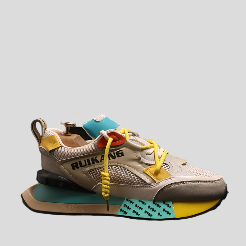 Pair of Rukkang sneakers with beige, yellow, and blue design on a light gray background